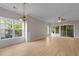 Bright living room showcasing hardwood floors, large windows, and sliding glass doors for seamless indoor-outdoor living at 5870 Longwood Dr. # 201, Murrells Inlet, SC 29576