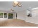 Spacious living room featuring an open floor plan, hardwood floors, natural light, and modern lighting fixtures at 5870 Longwood Dr. # 201, Murrells Inlet, SC 29576