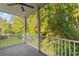 Relaxing porch offers serene views with lush greenery and a ceiling fan for added comfort at 5870 Longwood Dr. # 201, Murrells Inlet, SC 29576