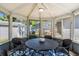 Cozy screened gazebo with seating for six around a round table and overhead ceiling fan at 6001 - 1842 S Kings Hwy., Myrtle Beach, SC 29575