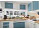 Charming kitchen with blue cabinets and wooden countertops, providing a cozy and inviting space at 6001 - 1842 S Kings Hwy., Myrtle Beach, SC 29575