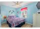 Cozy bedroom with light blue walls, ceiling fan, and floral bedding, creating a relaxing retreat at 6001-1643 S Kings Hwy., Myrtle Beach, SC 29575