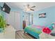 Bright bedroom featuring a colorful quilt, ceiling fan, and closet, offering a cozy and inviting atmosphere at 6001-1643 S Kings Hwy., Myrtle Beach, SC 29575