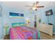Comfortable bedroom with a double bed, vibrant bedding, and an adjacent seating area visible through the open doorway at 6001-1643 S Kings Hwy., Myrtle Beach, SC 29575