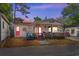 Charming home featuring a cozy front porch, vibrant pink doors, and a fun, welcoming beach vibe at 6001-1643 S Kings Hwy., Myrtle Beach, SC 29575