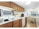 Bright kitchen with a double sink, practical appliances, and natural light, with a glimpse of a dining area at 6001-1643 S Kings Hwy., Myrtle Beach, SC 29575