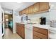 Efficient kitchen boasts practical appliances, wood cabinetry, and a convenient view to a bedroom at 6001-1643 S Kings Hwy., Myrtle Beach, SC 29575