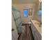 Bright bathroom featuring wood flooring, a sink, a toilet, and a shower with blue curtain at 6001-Z67 S Kings Hwy., Myrtle Beach, SC 29575
