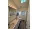 Bathroom with double sinks, toilet, tiled shower, wood floors, and a skylight at 6001-Z67 S Kings Hwy., Myrtle Beach, SC 29575