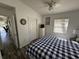 Cozy bedroom with wood-look floors, white walls, and a queen-sized bed with a blue and white checkered comforter at 6001-Z67 S Kings Hwy., Myrtle Beach, SC 29575