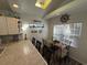 Bright dining area with wood-look floors, adjacent to the kitchen, with a view from the window and a skylight at 6001-Z67 S Kings Hwy., Myrtle Beach, SC 29575