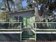 Inviting home with green accents, a spacious front deck and a tree growing through at 6001-Z67 S Kings Hwy., Myrtle Beach, SC 29575