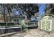 A small home with a matching shed is surrounded by trees on a sunny day at 6001-Z67 S Kings Hwy., Myrtle Beach, SC 29575