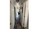 Bright hallway with wood-look floors and white walls that leads to the living room at 6001-Z67 S Kings Hwy., Myrtle Beach, SC 29575