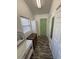 Bright hallway with wood-look floors, white walls, and a green door at 6001-Z67 S Kings Hwy., Myrtle Beach, SC 29575