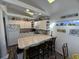Bright kitchen with white cabinets, tile countertops, skylights and wood-look floors adjacent to dining area at 6001-Z67 S Kings Hwy., Myrtle Beach, SC 29575