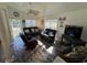 Inviting living room with leather sofas, wood-look floors, lots of natural light and white columns at 6001-Z67 S Kings Hwy., Myrtle Beach, SC 29575