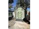 A shed with green trim, providing extra storage space for tools or equipment at 6001-Z67 S Kings Hwy., Myrtle Beach, SC 29575