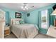 Charming bedroom with light blue walls, a comfortable bed, and bright natural lighting at 601 Jousting Ct., Conway, SC 29526