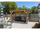 Outdoor kitchen area under a wood pergola with space for dining and grilling at 601 Jousting Ct., Conway, SC 29526