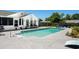 A swimming pool with a grey concrete pool deck, patio furniture, landscaping and fence at 601 Jousting Ct., Conway, SC 29526