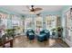 Charming sunroom filled with plants, comfortable seating and lots of windows at 601 Jousting Ct., Conway, SC 29526