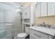 Clean bathroom with glass enclosed shower, marble vanity, and storage at 6309 N Ocean Blvd. # 14 E, North Myrtle Beach, SC 29582
