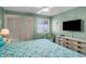 Comfortable bedroom featuring shuttered windows, ceiling fan, dresser, and a relaxing atmosphere at 6309 N Ocean Blvd. # 14 E, North Myrtle Beach, SC 29582