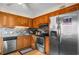 Well lit kitchen with stainless steel appliances, gray backsplash, and wooden cabinets at 6309 N Ocean Blvd. # 14 E, North Myrtle Beach, SC 29582