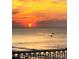 Beautiful sunset over the ocean with a pier silhouetted in the foreground at 6309 N Ocean Blvd. # 14 E, North Myrtle Beach, SC 29582