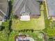 A neatly manicured backyard with a patio and lounging area, surrounded by lush landscaping at 806 Compass Point Dr., North Myrtle Beach, SC 29582