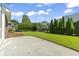 Well-maintained backyard with green lawn, brick patio, and lush landscaping creating a private outdoor space at 806 Compass Point Dr., North Myrtle Beach, SC 29582