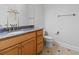 Bathroom featuring single vanity sink with wooden cabinets, granite countertops and modern commode at 806 Compass Point Dr., North Myrtle Beach, SC 29582