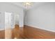 Bedroom with hardwood floors, ceiling fan, and access to a closet and bathroom at 806 Compass Point Dr., North Myrtle Beach, SC 29582