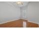 Bright bedroom featuring a ceiling fan, hardwood floors, and a window with plantation shutters at 806 Compass Point Dr., North Myrtle Beach, SC 29582