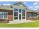 Exterior view of the brick home featuring a sunroom and outdoor patio at 806 Compass Point Dr., North Myrtle Beach, SC 29582