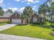 Charming brick home with a well-manicured lawn and mature palm trees at 806 Compass Point Dr., North Myrtle Beach, SC 29582