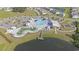 Aerial view of the community pool, lazy river, playground, and surrounding homes at 8076 Fort Hill Way, Myrtle Beach, SC 29579