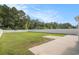 Spacious backyard with a large green lawn, concrete patio, and a white fence at 8076 Fort Hill Way, Myrtle Beach, SC 29579