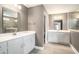Elegant bathroom featuring double sink vanity with a marble countertop and a walk-in shower at 8076 Fort Hill Way, Myrtle Beach, SC 29579