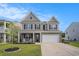 Charming two-story home with gray siding, black shutters, and a well-manicured front lawn at 8076 Fort Hill Way, Myrtle Beach, SC 29579
