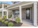 Inviting front porch with white rocking chairs and a beautifully landscaped garden at 8076 Fort Hill Way, Myrtle Beach, SC 29579