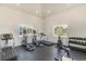 Bright gym with treadmills, ellipticals, weights, and white shiplap walls with natural light at 8076 Fort Hill Way, Myrtle Beach, SC 29579