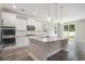 Modern kitchen with granite countertops, stainless steel appliances, and hardwood floors at 8076 Fort Hill Way, Myrtle Beach, SC 29579