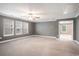 Large living room featuring plush carpeting and lots of natural light at 8076 Fort Hill Way, Myrtle Beach, SC 29579