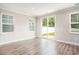 Bright living room featuring a sliding glass door and modern flooring at 8076 Fort Hill Way, Myrtle Beach, SC 29579