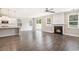 Open-concept living room with hardwood floors, fireplace, and a view of the kitchen at 8076 Fort Hill Way, Myrtle Beach, SC 29579
