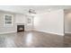 Cozy living room featuring a fireplace, hardwood floors, and natural light at 8076 Fort Hill Way, Myrtle Beach, SC 29579