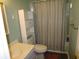 The bathroom features a sink, toilet, and shower with storage shelves next to it at 811 Rogers Rd., Myrtle Beach, SC 29577