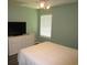 A cozy bedroom featuring a window, ceiling fan, dresser and neutral paint at 811 Rogers Rd., Myrtle Beach, SC 29577